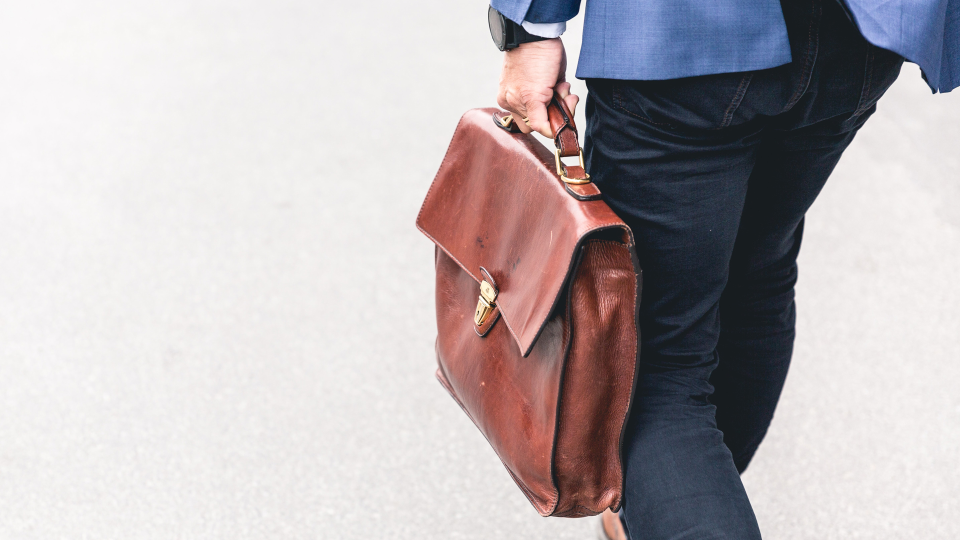 Close up of man walking with a briefcase