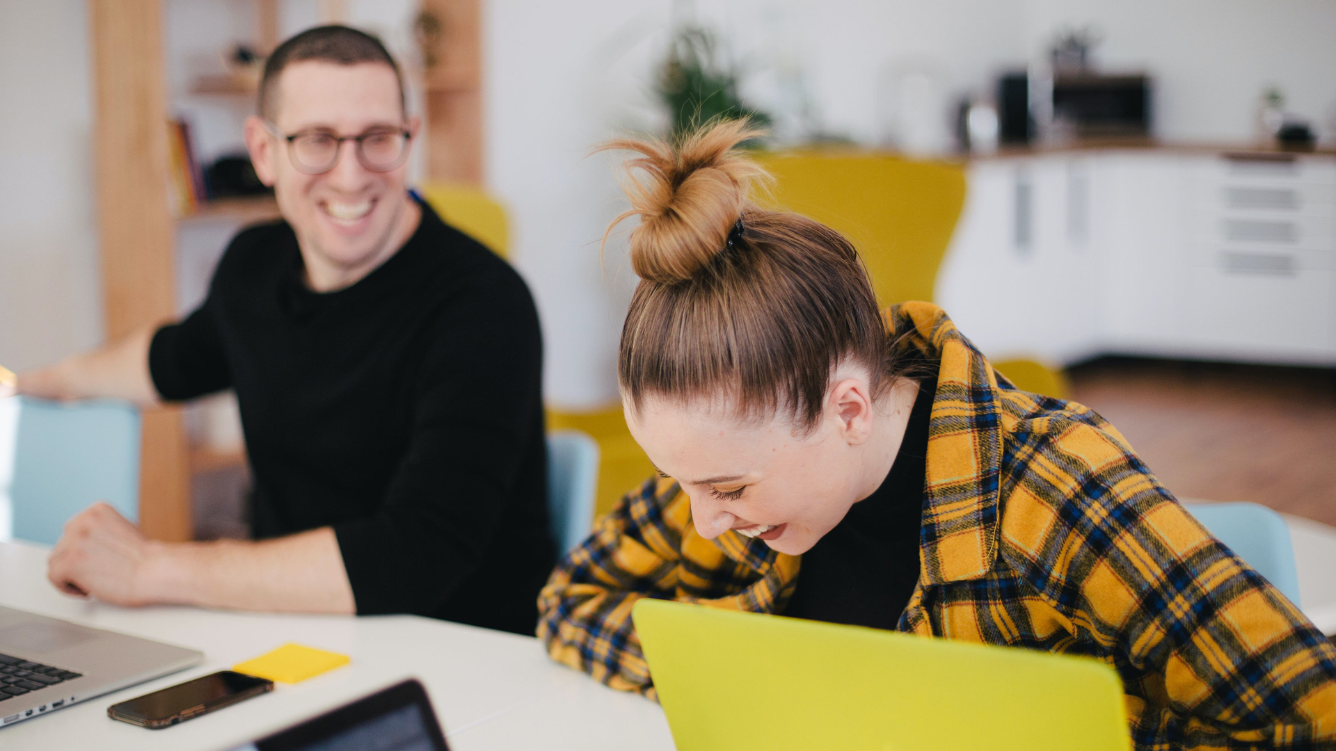 Woman laughing in an office environment