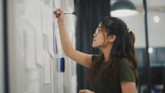 Student writing on a whiteboard